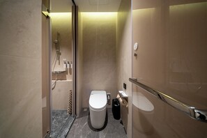 A modern bathroom with a toilet, shower, and hand sanitizer dispensers. - SSAW Boutique Hotel Shenzhen Snow World (Shenzhen)