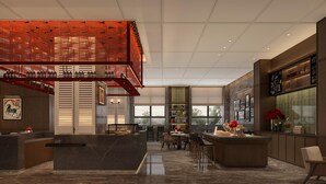 Una cocina moderna con una isla central, un botellero y un comedor con sillas y mesas.