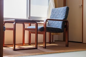 A room with a wooden desk and chair, a window with curtains, and a carpeted floor. - KKRShirahamamihamasou (Shirahama)