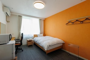 A hotel room with a bed, desk, chair, and a radiator. - KKRShirahamamihamasou (Shirahama)