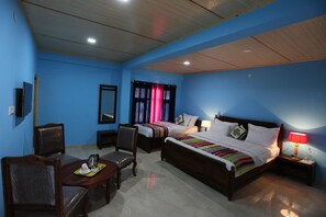 A hotel room with two beds, a desk, a chair, a television, and a mirror. - Spiti Heritage Himalayan Brothers (Spiti)