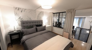 A modern bedroom with a large bed, bedside tables, a nightstand, a window with curtains, and a view of the outside. - Innocondo Extended Stay Changning Yuyuan (Shanghai)