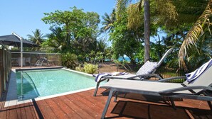 A poolside area with lounge chairs, a pool, and a view of the ocean. - The Barrington- Ocean Front Views (Wongaling Beach)