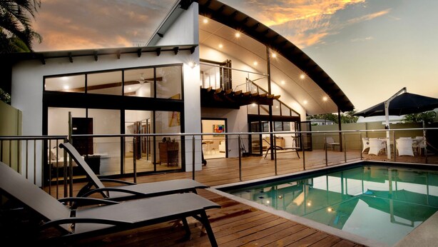A modern house with a pool, outdoor seating, and a covered patio area. - The Barrington- Ocean Front Views (Wongaling Beach)
