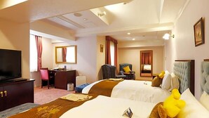 A hotel room with two beds, a desk, a television, and a chair. - Hotel Konigs Krone Kobe (Kobe)