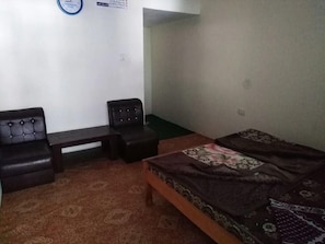 A room with a bed, a sofa, a chair, and a small table. - Green City Hotel And Restaurant (Balakot)