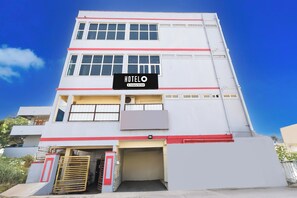 A multi-story building with a sign indicating it is a hotel. - Hotel O Bolligudem (Hyderabad)