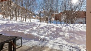 A snowy outdoor area with trees and buildings in the background. - Rã©sidence Les Crãªts 1 - Val-d'isã¨re (Val-d'Isere)