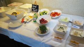 A buffet table with various food items and utensils. - Hotel Restaurant Stv Ckl (Schwanberg)