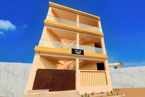 A multi-story hotel with a sign reading 'HOTEL' and balconies on each floor. - OYO Hotel O Arjun Ganj (Lucknow)