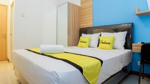 A hotel room with a bed, a nightstand, a chair, and a wardrobe. - My Room at Paskal Hypersquare (Kota Bandung)