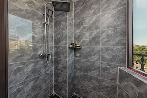 A modern shower with a handheld showerhead and a wall-mounted control panel. - Premium Madelis Hotel (Hanoi)