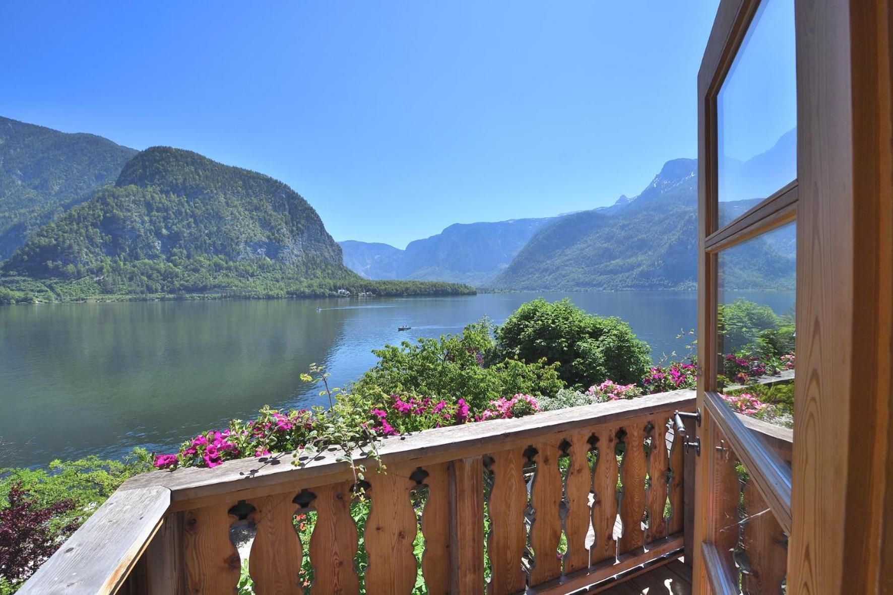 A balcony with a view of a lake and mountains.
