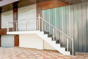 A staircase with metal railings and a patterned floor.