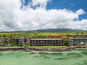 A coastal hotel with multiple buildings, a clear view of the ocean, and a mountainous landscape in the background. - Oceanfront 1BD with Unobstructed Ocean, Lanai & Island Views & Pool -Kaleialoha 415 (Lahaina)