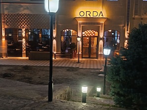 A building with a sign reading 'ORDA' at the entrance, featuring a tiled facade and a central doorway. - Apartment Valley of legends mall (Namangan)