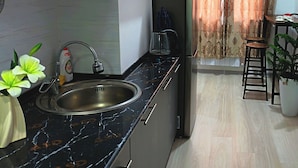 A modern kitchen with a sink, a coffee maker, and a cabinet. - Apartment Valley of legends mall  (Namangan)