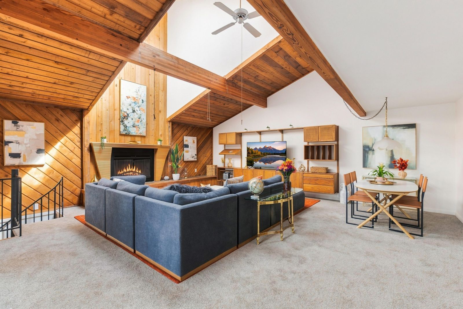 Geräumiges Loft mit hohen Decken, Kamin, großzügigem Ecksofa, Essbereich und Fernseher.