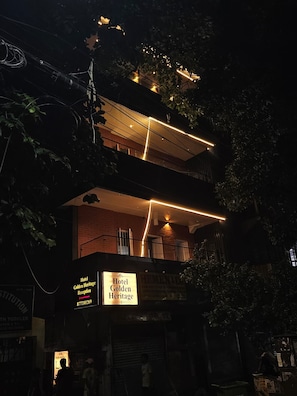 A multi-story building with illuminated signage for Hotel Golden Heritage Reception. - Hotel Golden Heritage (Kolkata)