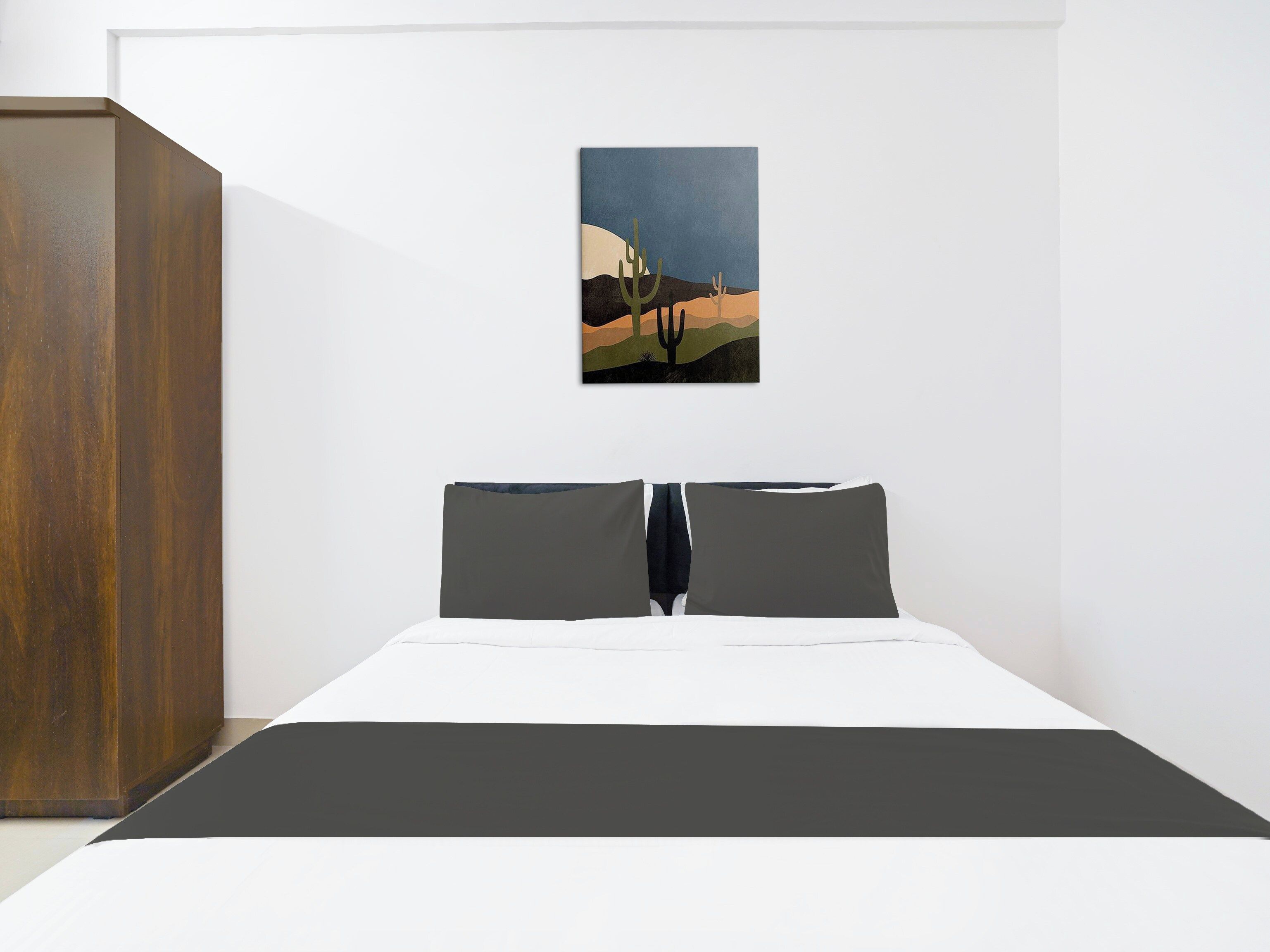 A bedroom with a bed, a wooden wardrobe, and a painting on the wall.