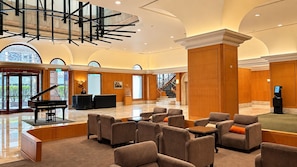 A spacious lobby with a grand piano, comfortable seating, a reception desk, and a staircase leading to upper floors. - BERI HOTEL Kaohsiung (Kaohsiung City)