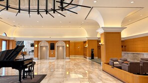 A spacious lobby with a grand piano, comfortable seating, and a marble floor. - BERI HOTEL Kaohsiung (Kaohsiung City)