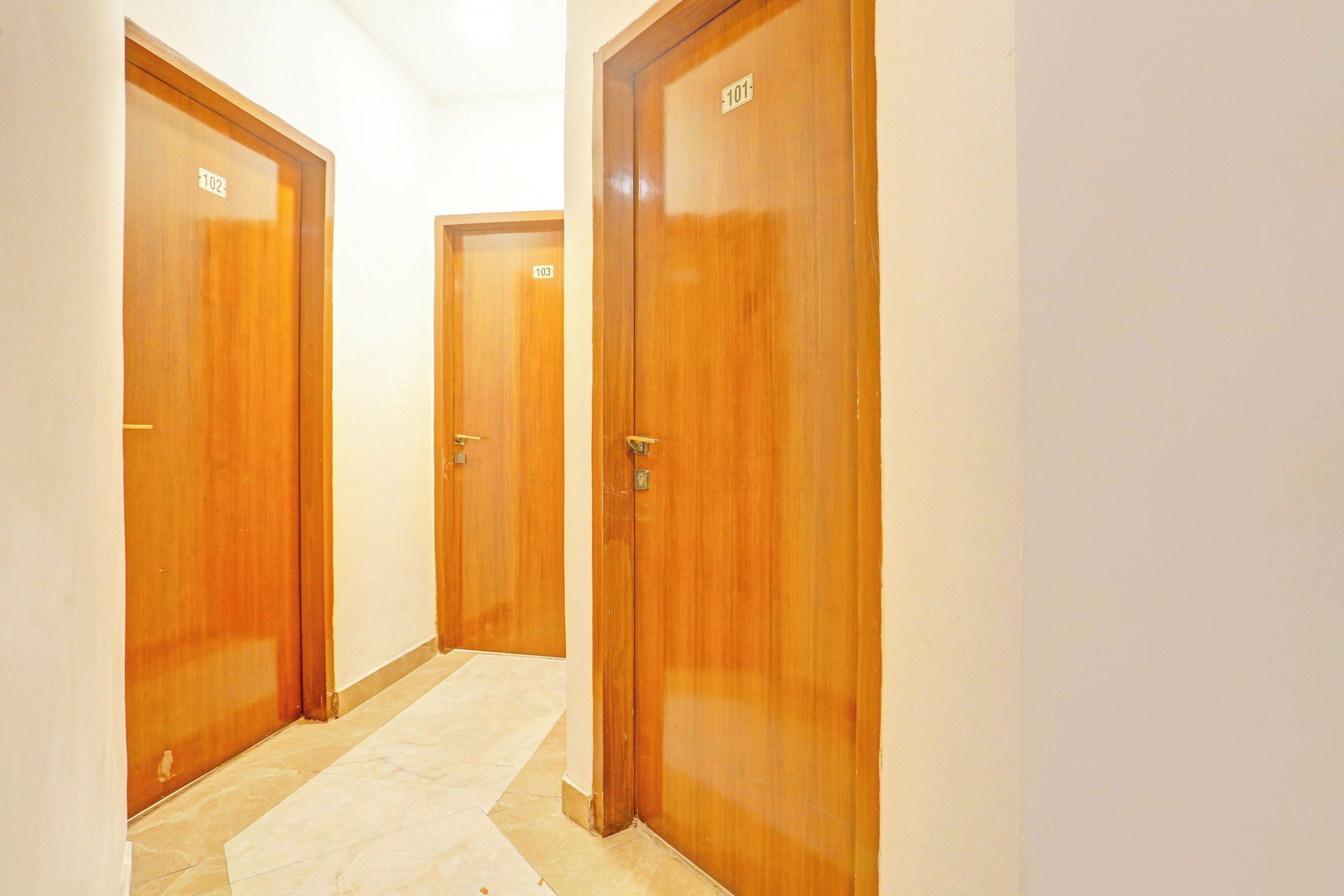 A corridor with wooden doors numbered 101, 102, and 103.