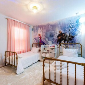 Quarto com duas camas de solteiro, um guarda-roupa e um mural de uma paisagem nevada.
