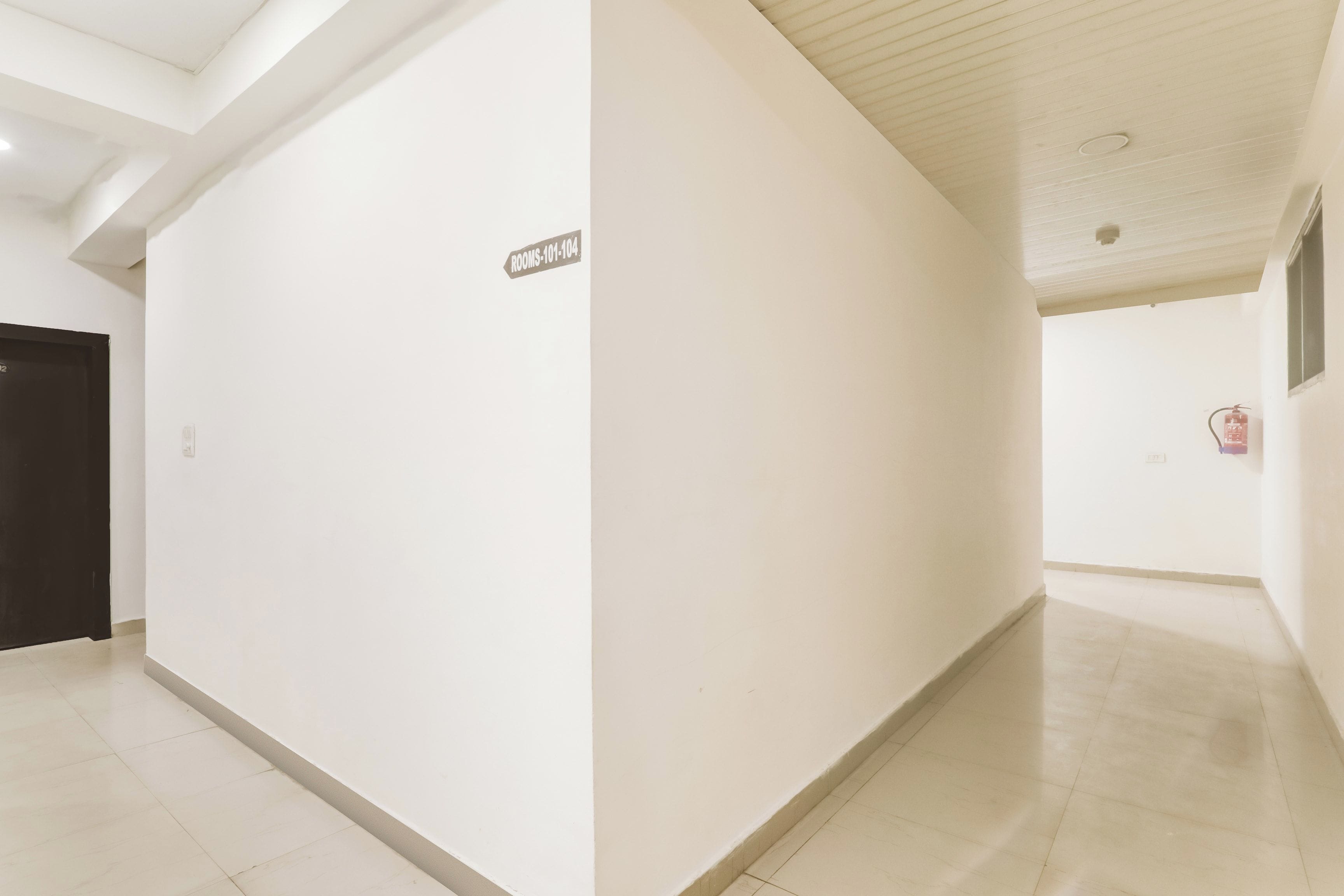 A corridor with a sign indicating rooms 101-104.
