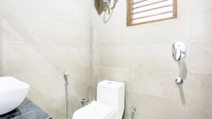 Un bagno con il water, una doccia e un lavandino.