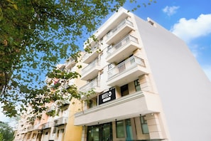 A multi-story hotel with balconies and a sign indicating it is a company-owned hotel.