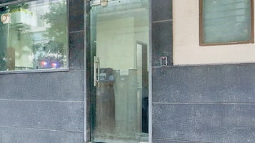 A building facade with a glass door and windows.