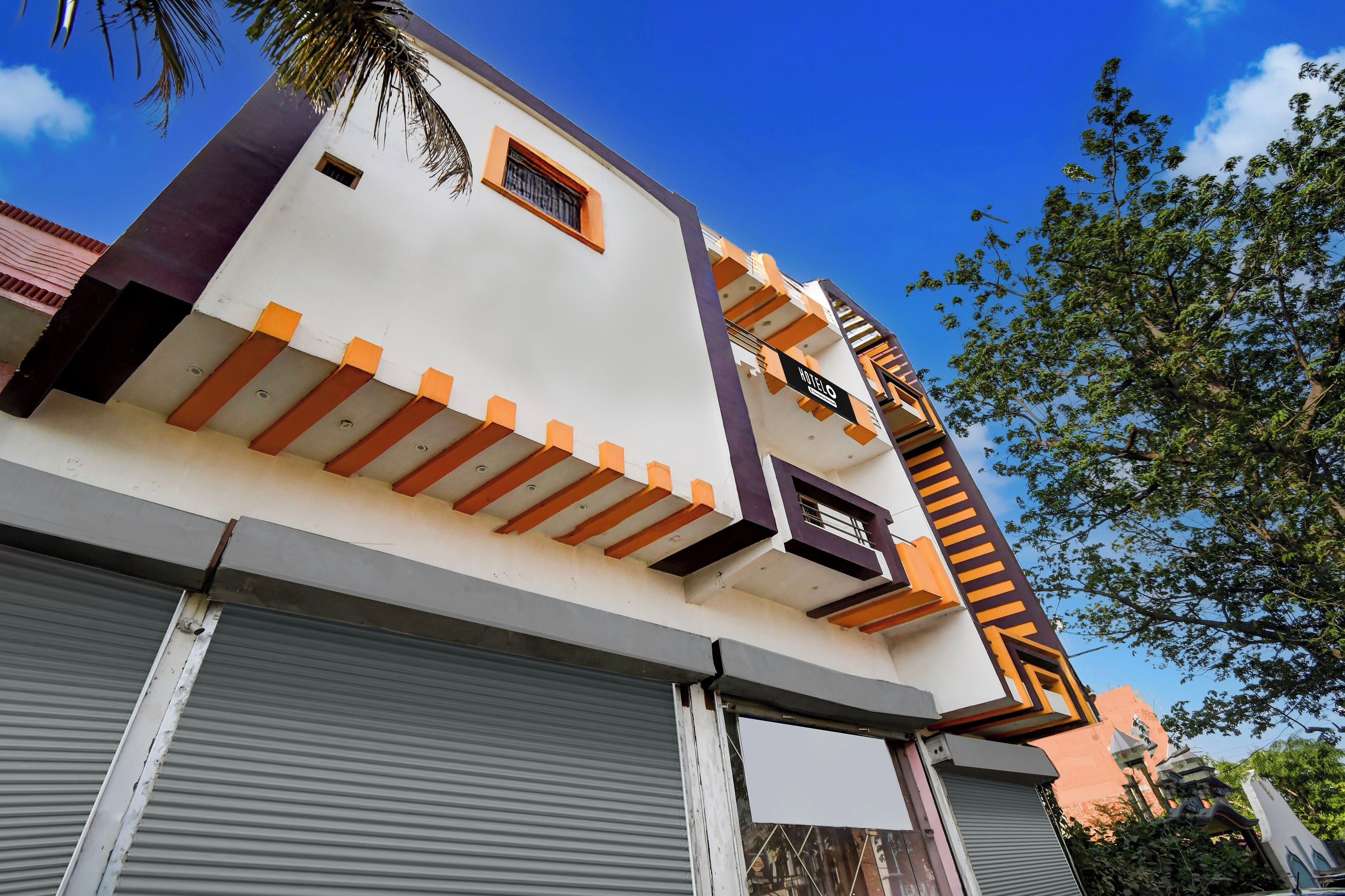A multi-story hotel with a modern architectural design, featuring balconies and a prominent 'HOTEL' sign.