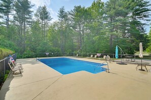 A rectangular swimming pool with a metal ladder, surrounded by a concrete deck. - Mountain-View Cedar Creek Condo w/ Trail Access (Conway)