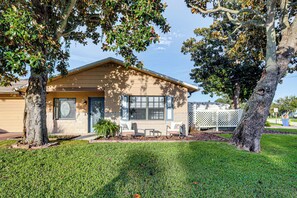 A single-story house with a front porch, a small lawn, and two trees. - Boat Ramp, Fishing Pier & Game Room Retreat (Edgewater)
