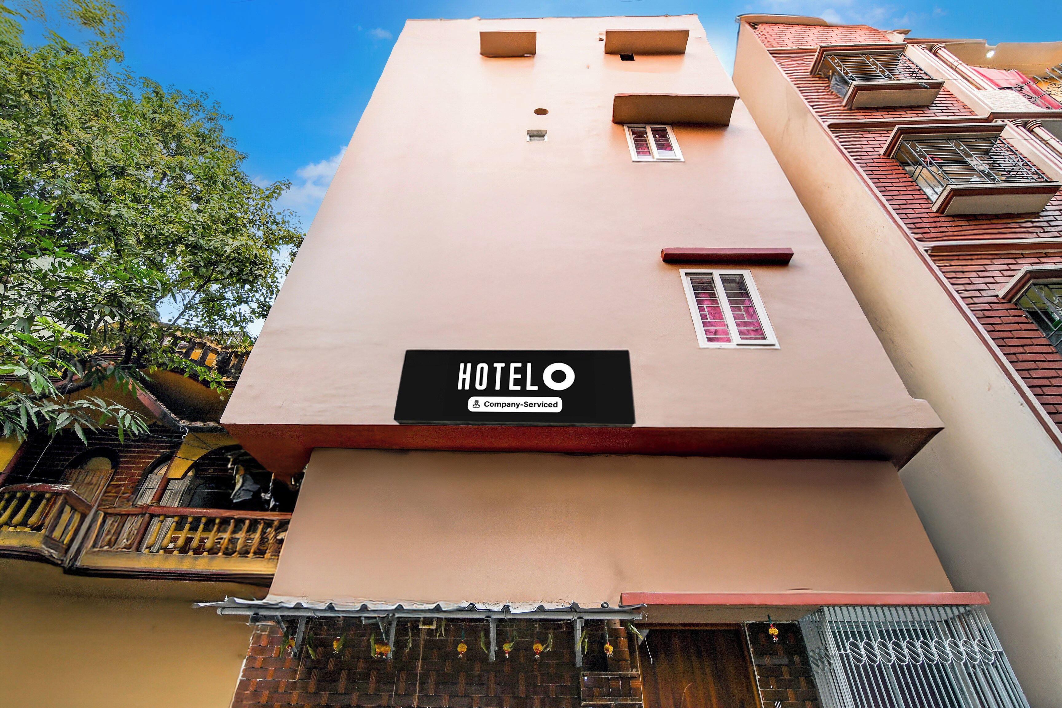 A hotel building with a sign that reads 'HOTEL' and 'Company-Serviced.'