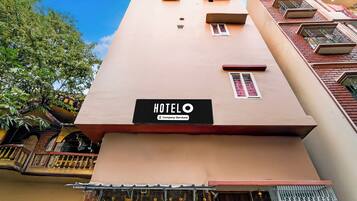 A hotel building with a sign that reads 'HOTEL' and 'Company-Serviced.'