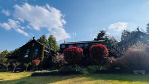A two-story house with a garden in front.