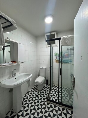 A bathroom with a white sink, toilet, and shower enclosure. - No 19 suite pendik otel 2 (Pendik)