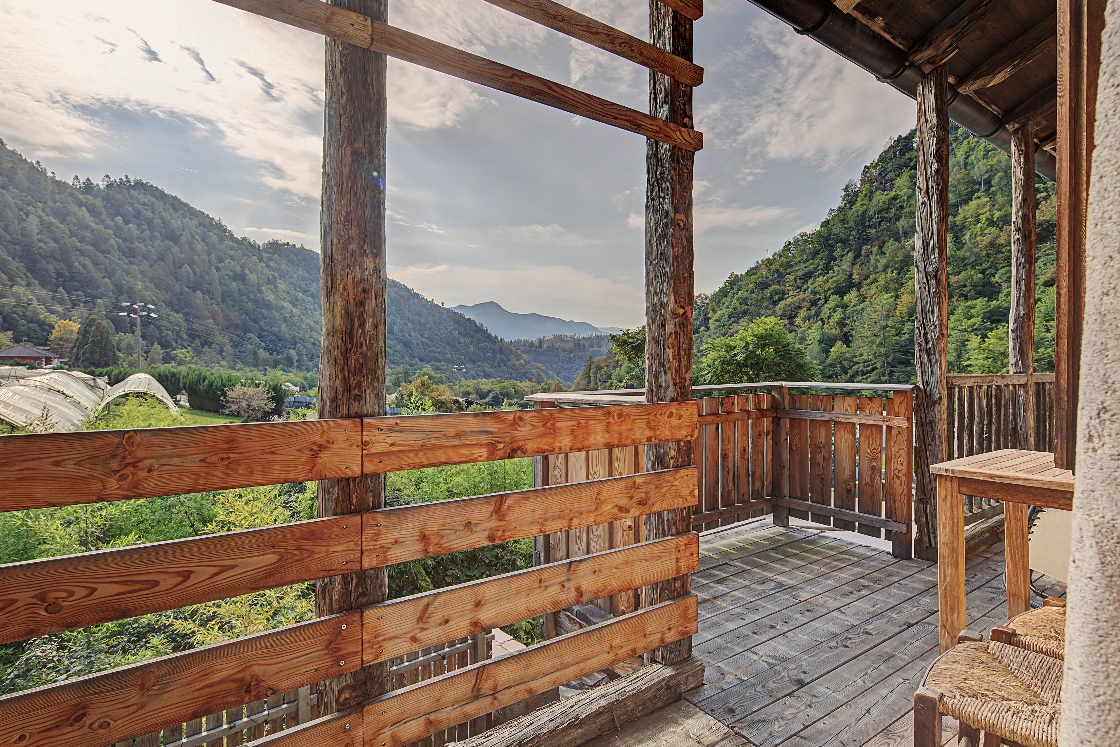 Eine Holzterrasse mit Blick auf eine gebirgige Landschaft.