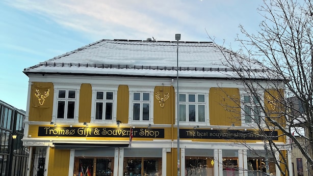 A two-story building with a shop on the ground floor named 'Tronso Gift & Souvenir Shop.' - Historic Strandgata 36 (Troms)