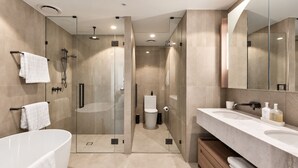 A modern bathroom with a freestanding bathtub, a glass-enclosed shower, and a vanity with a large mirror. - Maison Quatre | Brisbane Skyline & River Escape (Brisbane City)