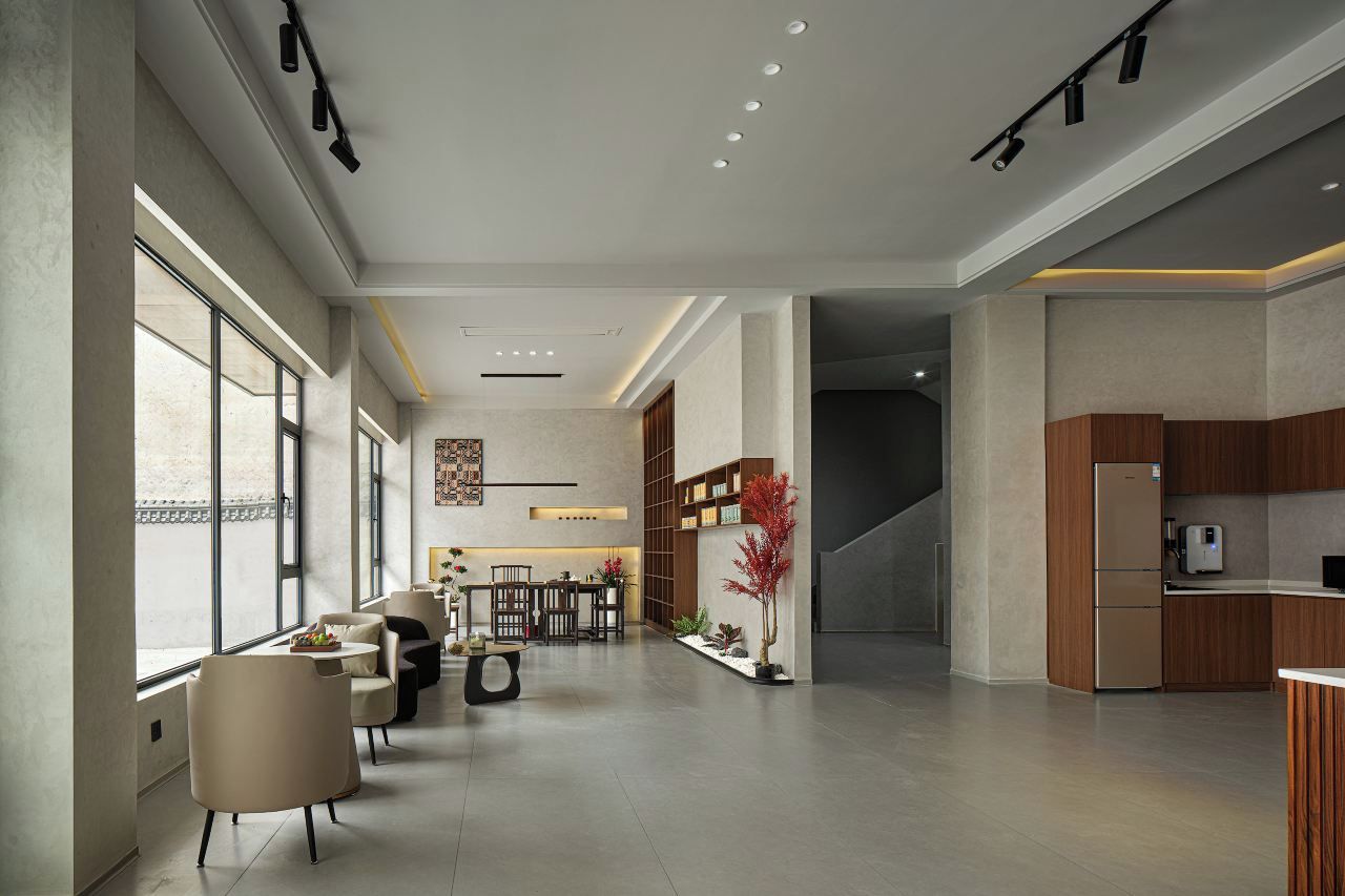 A modern interior with a dining area, kitchen, and seating space.