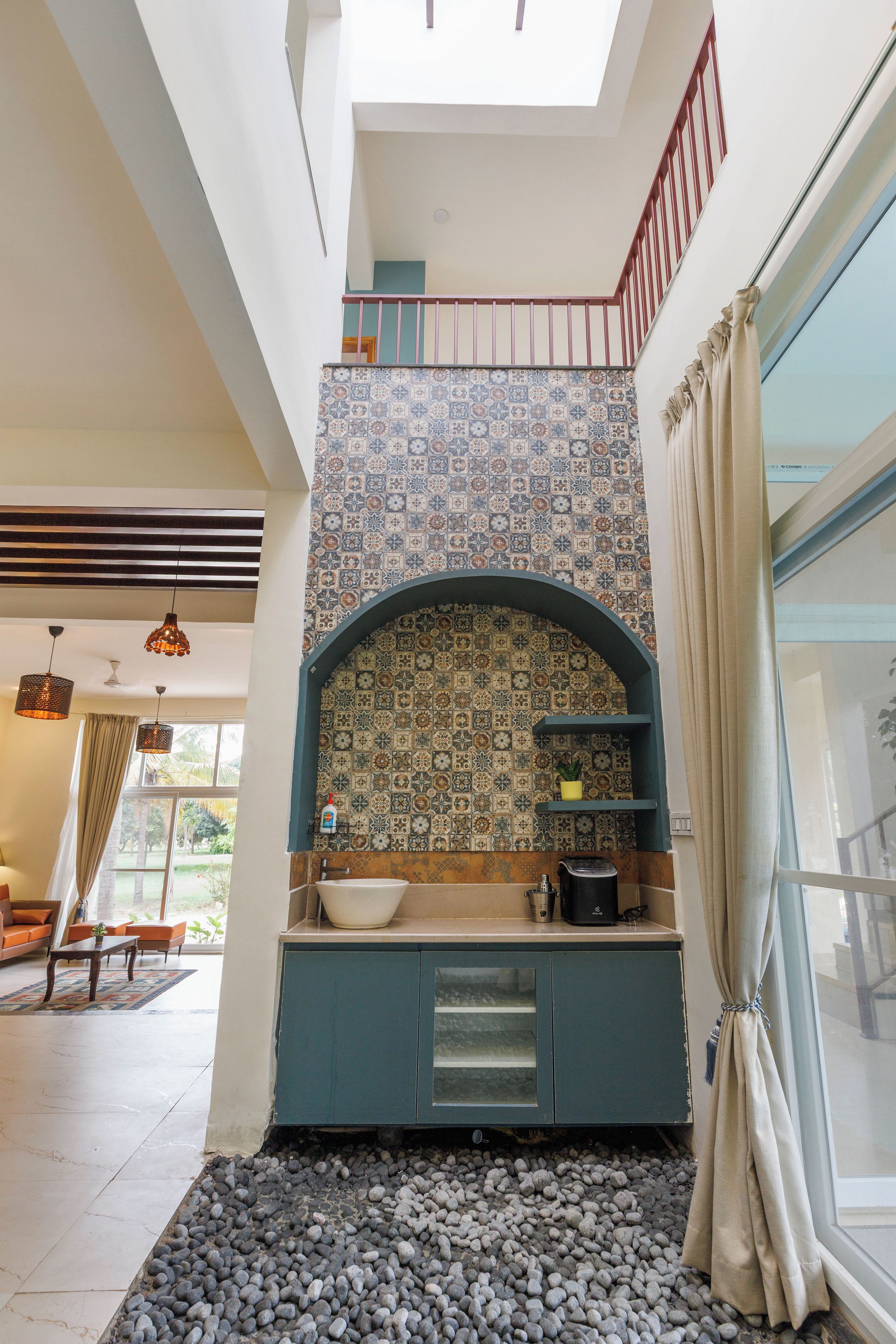 A modern kitchen with a tiled backsplash, a built-in sink, and a coffee machine.