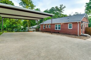 A two-story brick house with a covered patio area.