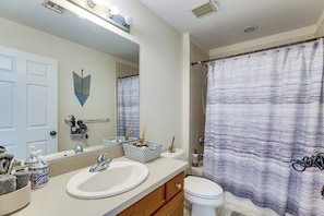 A bathroom with a white sink, a mirror, a toilet, and a shower curtain. - Spacious Group Getaway Near Grounds For Sculpture (East Windsor)