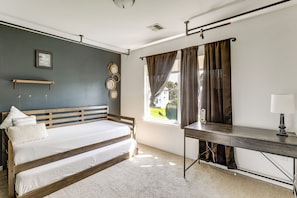 A bedroom with a bed, a desk, a window with curtains, a wall-mounted mirror, and a picture frame. - Spacious Group Getaway Near Grounds For Sculpture (East Windsor)