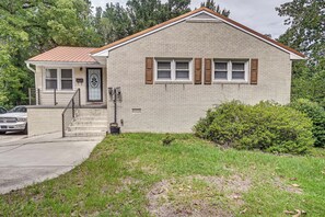 A two-story house with a brick facade, a front porch, and a visible mailbox. - Fayetteville Fall Getaway | Family & Pet Friendly (Fayetteville)