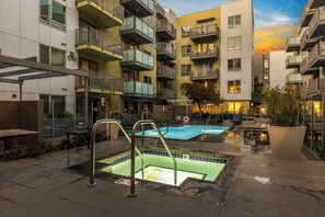 A rooftop pool area with multiple pools, outdoor seating, and a view of the surrounding buildings. - Pool & Private Balcony! Luxe NoHo Extended Escape (North Hollywood)