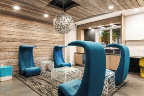 A modern interior with a wooden ceiling, a hanging light fixture, and a kitchen area with a window view. - Pool & Private Balcony! Luxe NoHo Extended Escape (North Hollywood)